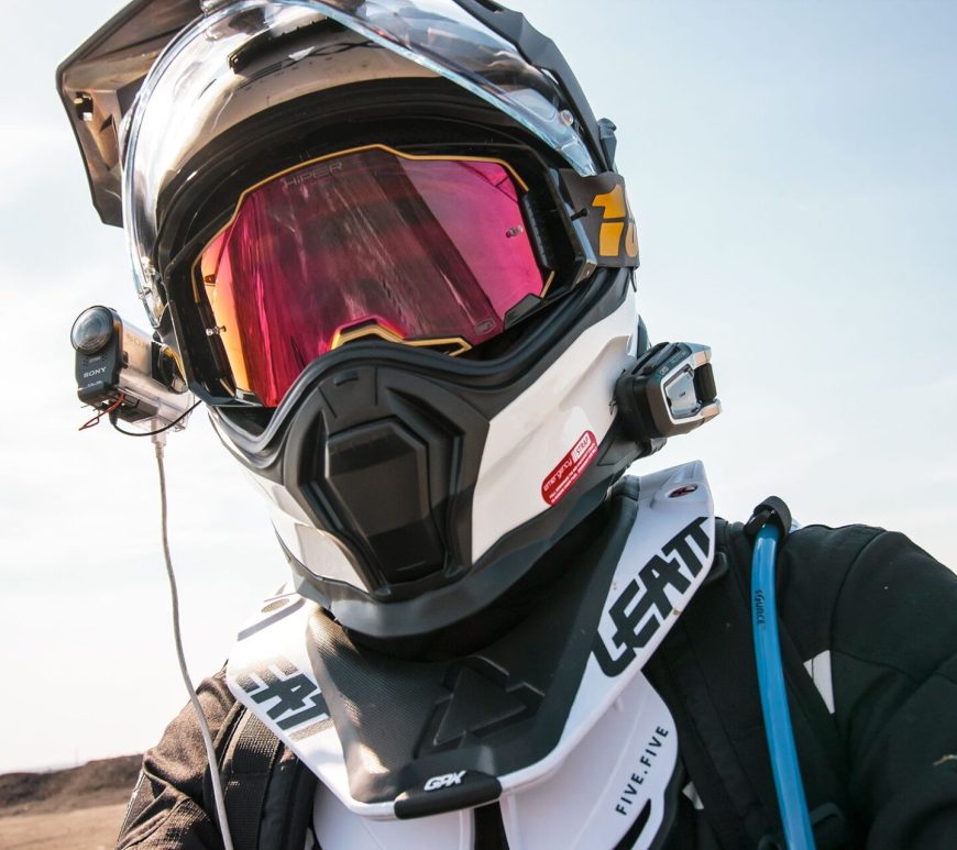 Close-up of a dirt bike rider wearing a helmet with a camera mounted on it.